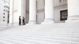 two government officials standing outside a government building on a large flight of stairs