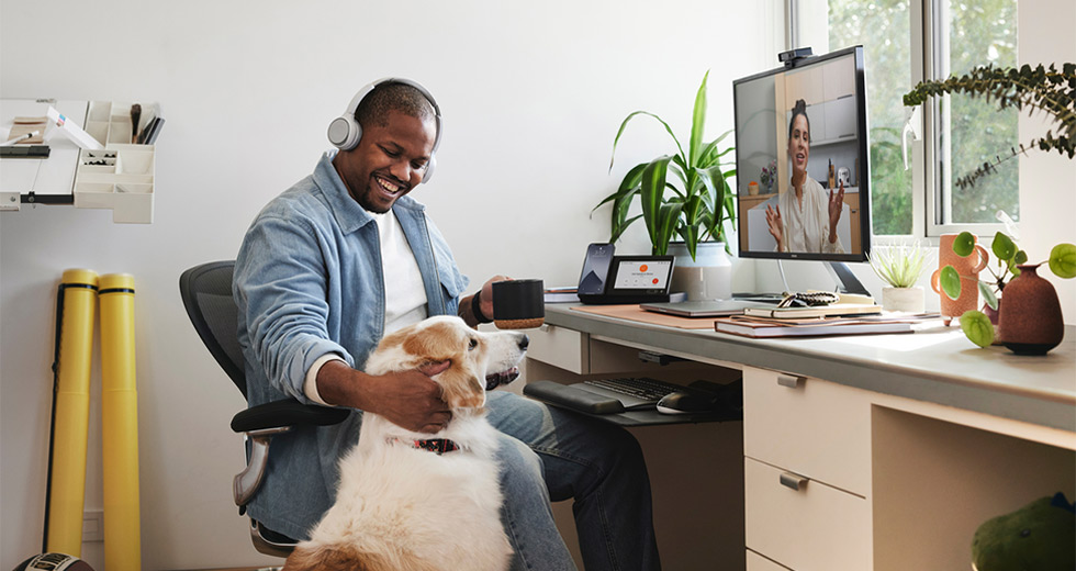 Man Petting His Dog At Home On Webex Call With Coworker