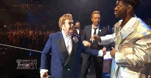 Elton John and Lil Nas X embracing at awards show