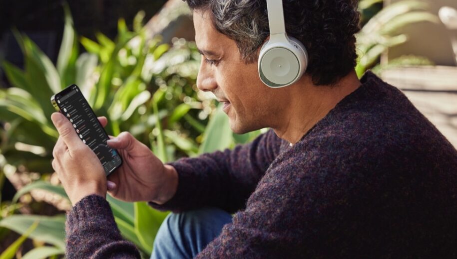 Man with headset listening to audio with smartphone_ccexpress-2