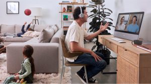 man wearing headphones in front of computer