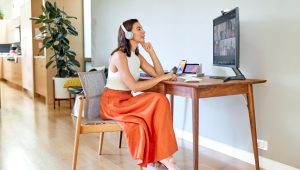 Lady wearing headphone listening in on a meeting