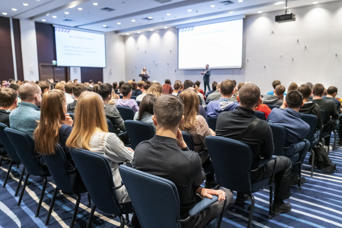 Image of a conference that takes place in a large conference room