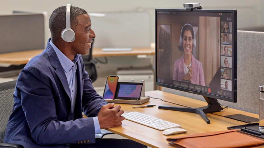 Man Smiling At Woman On Webex Call, Both Using Various Communication Tips