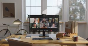 A home office setup, featuring a monitor with the Cisco Desk Cam 1080p