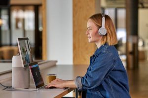 Redhead woman on meeting using Room OS