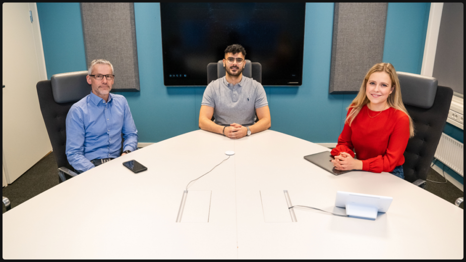 Webex Desk Before Frames Feature, Displaying Three Individuals At Conference Table