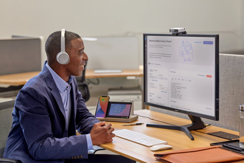 Man In Office Clothes With Headphones Using Webex Connect