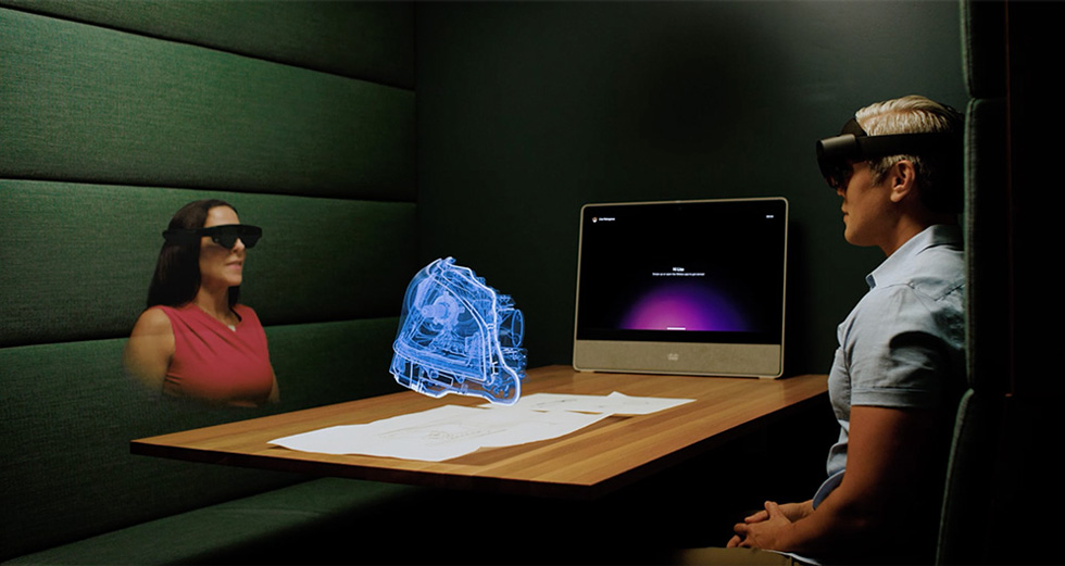 Two People Sitting At Table Viewing Webex Hologram