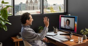 Frictionless Hybrid Work Feature, Man At Home Waving During Webex Meeting