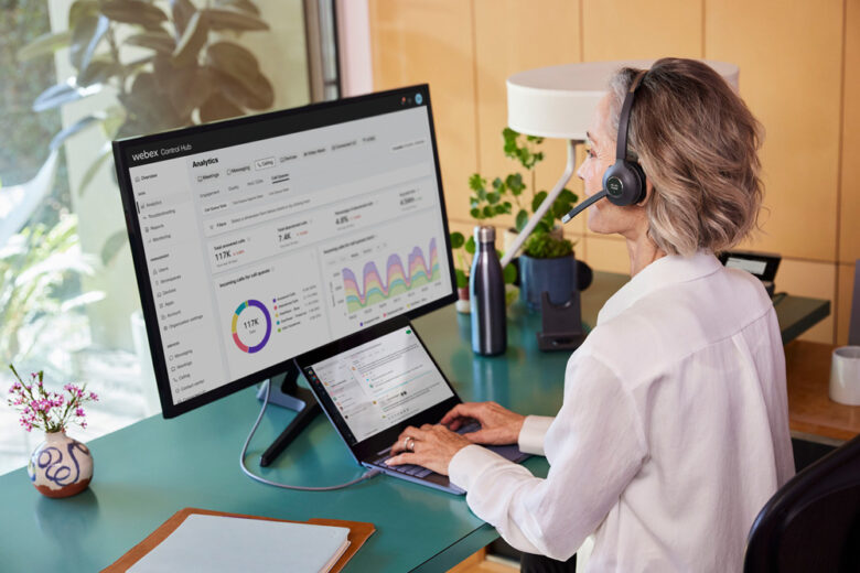 Woman With Headset Viewing Webex Control Hub Analytics Screen
