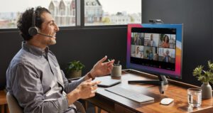 Man On Cisco Headset Speaking To Webex Meeting Participants From Home Office