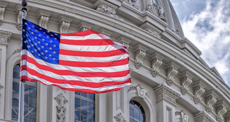 Front Of U.S. Government Building With American Flag On Poll