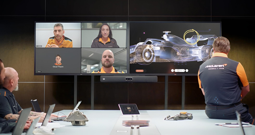 McLaren Conferencing Room With Team Collaborating With Additional Team Members Via Webex Meetings