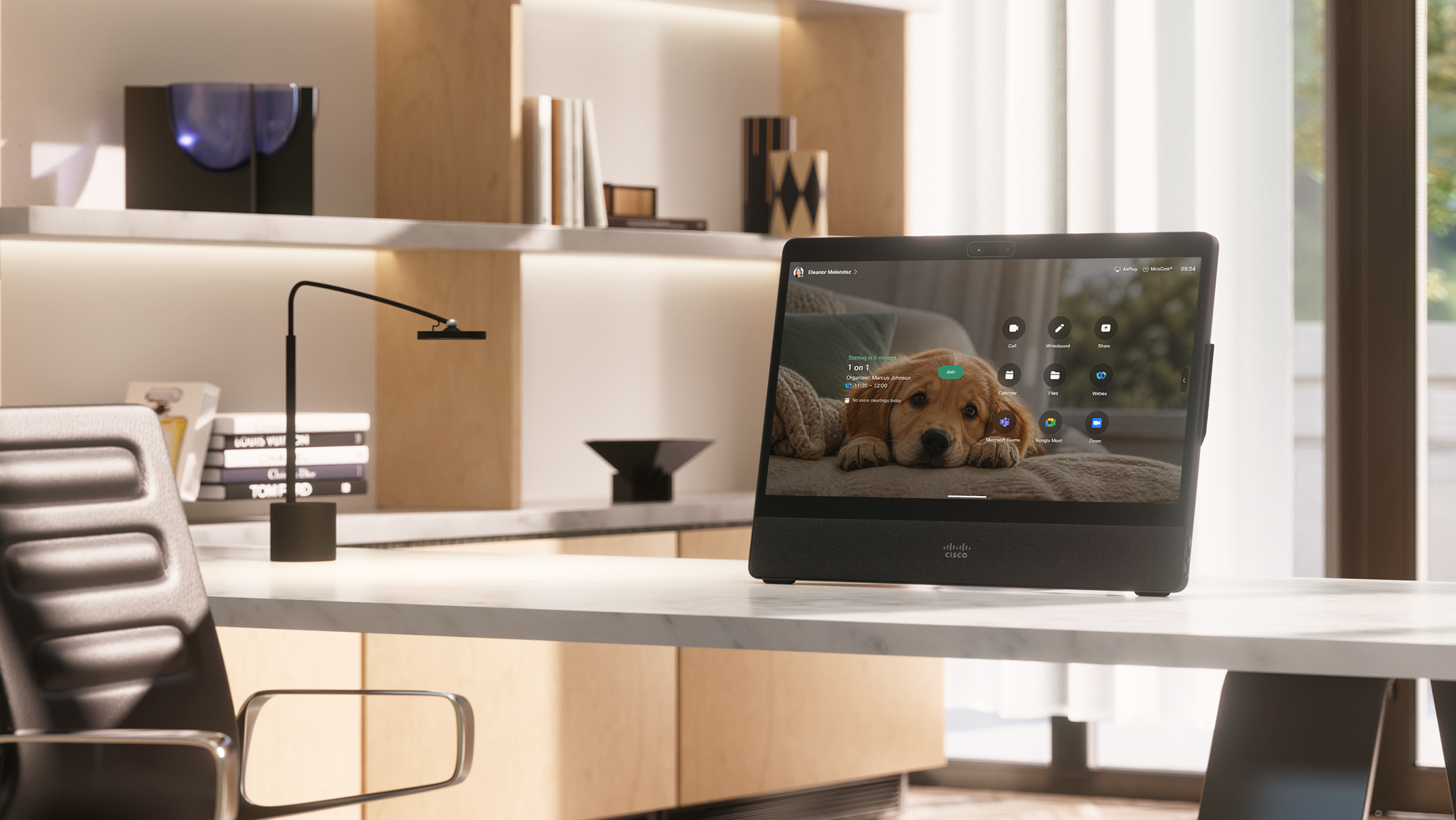 Cisco Desk Pro G2 in a modern home office, displaying a puppy wallpaper, an upcoming meeting, and collaboration controls.
